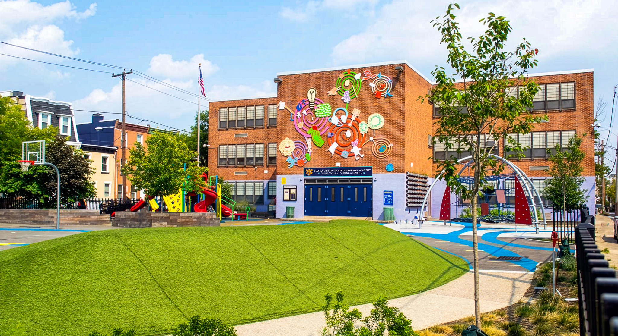 Marian-Anderson-Schoolyard Exterior view of Marian Anderson Neighborhood Academy featuring a colorful mural and school playground.