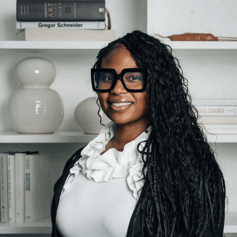 Dr. Nicole Patterson, Principal Dr. Nicole Patterson, Principal of Marian Anderson Neighborhood Academy, smiling in front of a school bulletin board.